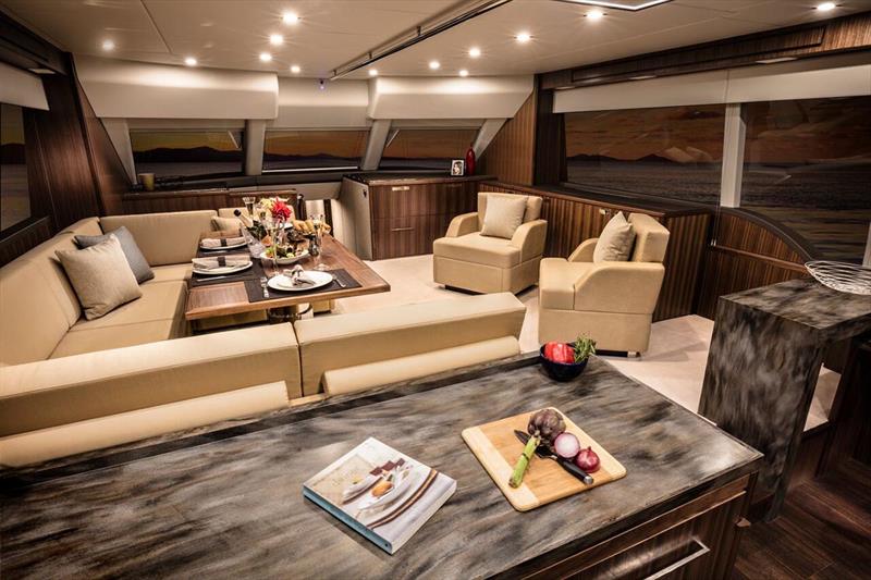 Luxurious saloon with a U-shaped leather lounge around the beautifully finished dining table - photo © Riviera Australia