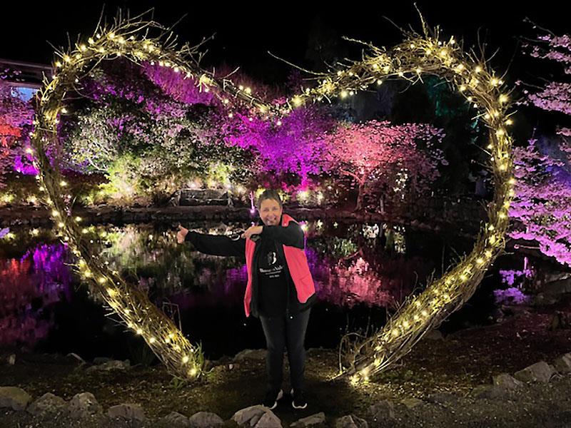 Fiona Rammell in amongst the blossoms - photo © Awanui NZ