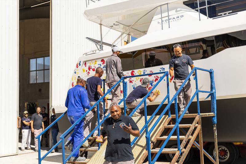 3000th Leopard and all the workers who built it put their handprints on the vessel ahead of her Christening - photo © Leopard Catamarans