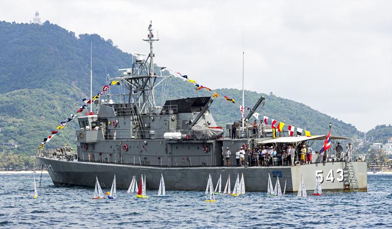 The RC division and the warship! Phuket King's Cup Regatta 2019 photo copyright Guy Nowell / Phuket King's Cup taken at Royal Varuna Yacht Club and featuring the Radio Sailing class