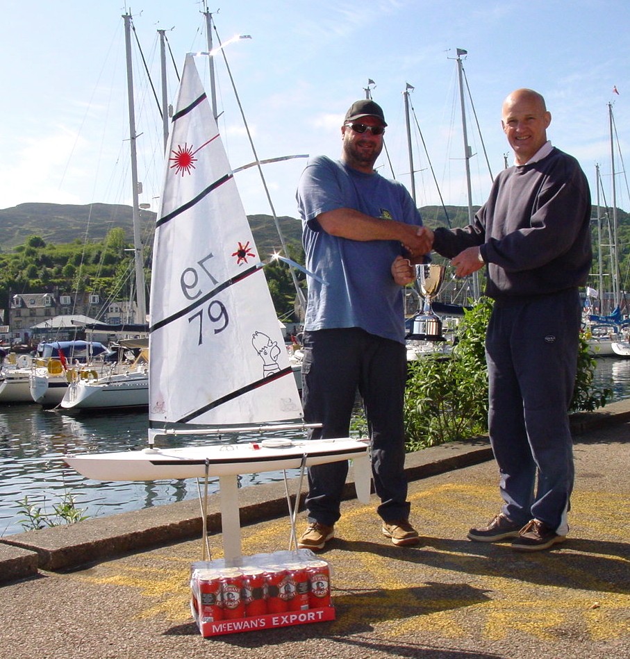 John Hardie, on behalf of Shanks, presented Mark with the Shanks Mini Scottish Series trophy photo copyright Mark Homer taken at  and featuring the RC Laser class