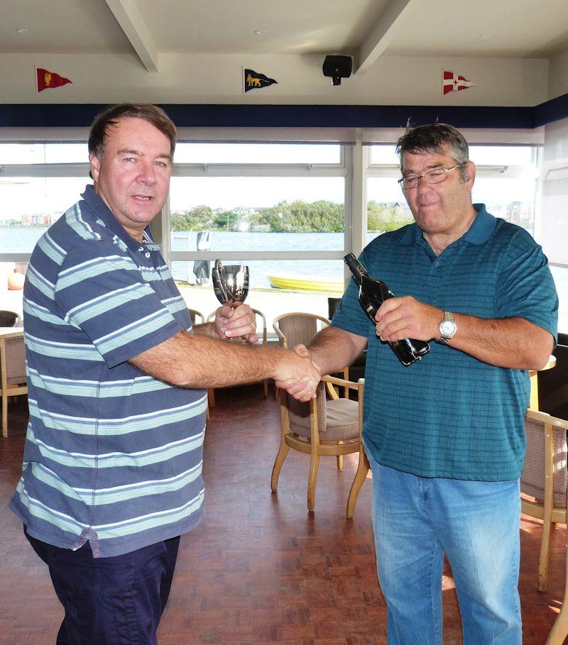 David Fowler is presented the RC Laser Northern District Championship trophy by Skip Reaser photo copyright Rob Wheeler taken at West Lancashire Yacht Club and featuring the RC Laser class