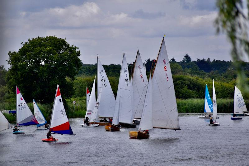 The fleet sailing downwind during Horning Sailing Club Regatta Week 2022 photo copyright Holly Hancock taken at Horning Sailing Club and featuring the Rebel class