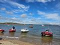 Solway Yacht Club Cadets Adventure Day - RIBs on Hestan Island beach, anchored bigger boats off shore © Finlay Train