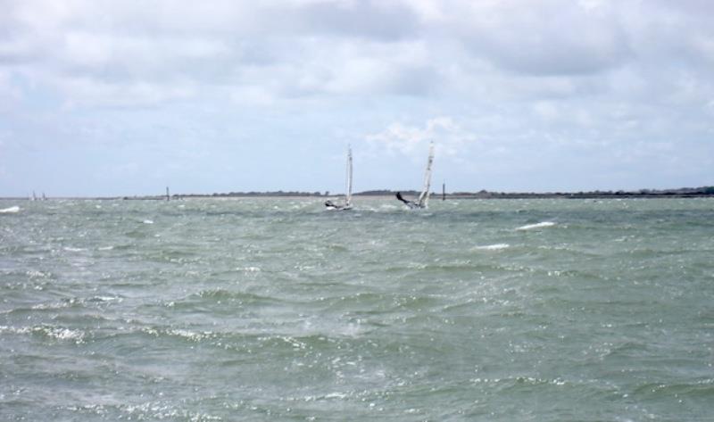 Gregory keeping his boat dead flat in a 25 knot gust. Chapeau photo copyright RS Class Associations taken at Lymington Town Sailing Club and featuring the RS100 class