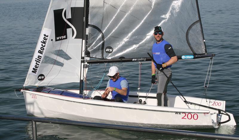 Endeavour 2023: Christian Birrell and Luke Patience (Merlin Rocket) waiting for the wind to fill in earlier today photo copyright Sue Pelling taken at Royal Corinthian Yacht Club, Burnham and featuring the RS200 class