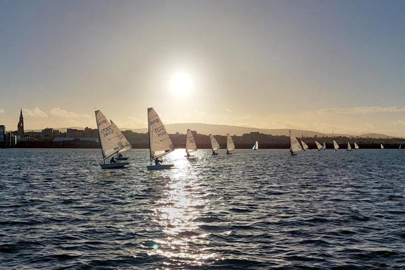 In winter sunshine, a “flight” of Aeros lead the ILCAs on the downwind leg of the sausage in Race 4 of the Viking Marine DMYC Frostbite Series 1 day 2 photo copyright Cormac Bradley taken at Dun Laoghaire Motor Yacht Club and featuring the RS Aero 7 class