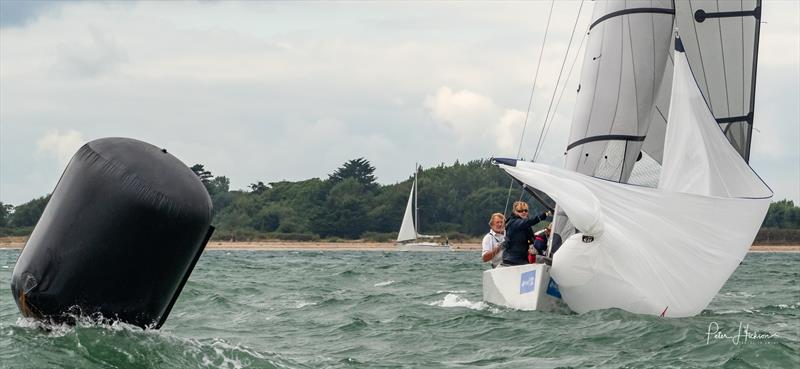Ossie Stewart and crew drop their spinnaker during Chichester Harbour Race Week photo copyright Peter Hickson taken at Hayling Island Sailing Club and featuring the RS Elite class