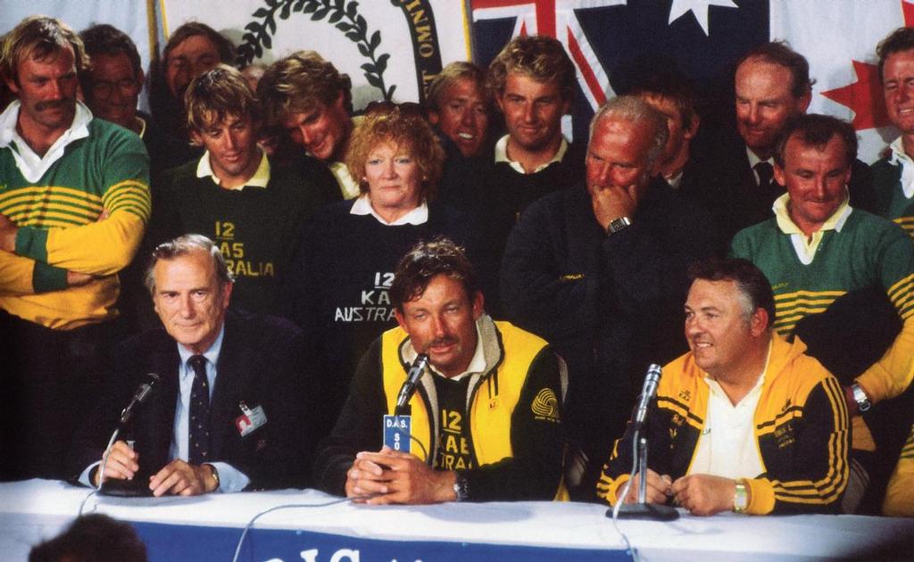 Alan Bond (right), skipper John Bertrand  (centre) and a po-faced US Press Officer at the final media conference. Grant Simmer to the immediate left of Eileen Bond at the Media Conference in the State Armoury, following Australia II, s win in 1983. photo copyright Paul Darling Photography Maritime Productions www.sail-world.com/nz taken at  and featuring the  class