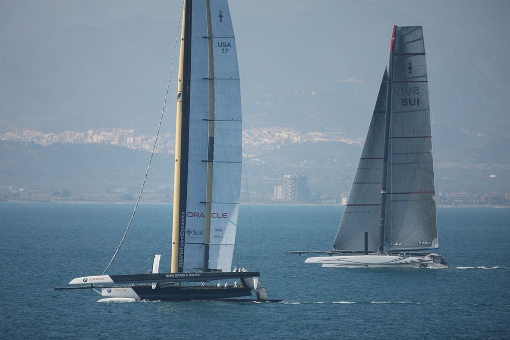 BMW Oracle with Alinghi in the background off Valencia - photo © BMW Oracle Racing Photo Gilles Martin-Raget www.bmworacleracing.com