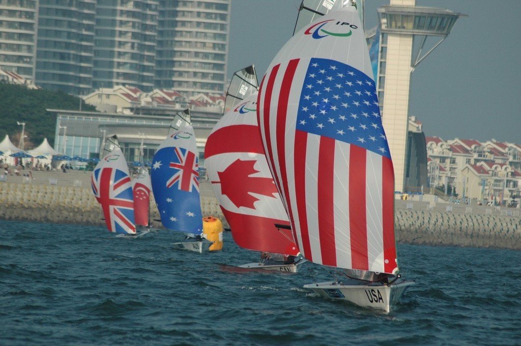 Nick Scandone and Maureen Mckinnon-Tucker on their way to winning a Gold medal in Qingdao photo copyright Lynn Fitzpatrick taken at  and featuring the  class