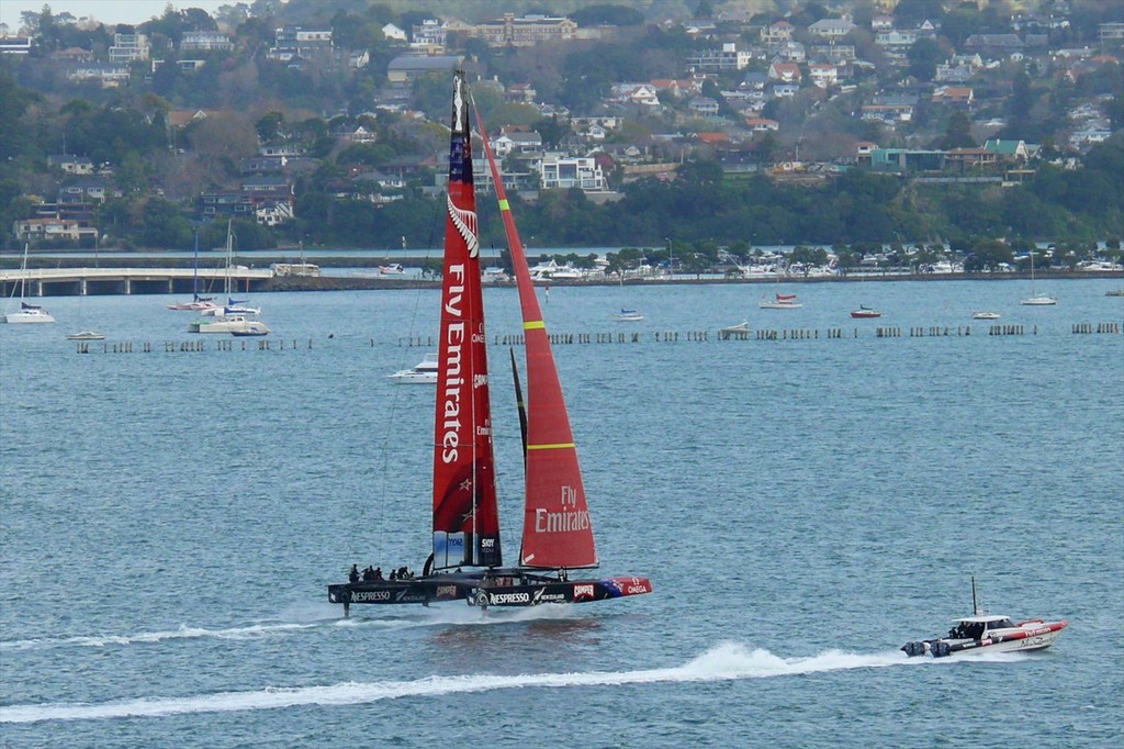 5 - AC72 - New Zealand fully lifted on her L-Foils and sailing on the Waitemata Harbour, Auckland, New Zealand. The windward L-foil is shown clear of the water in compliance with AC racing rules. © Swan Images http://www.sail-world.com