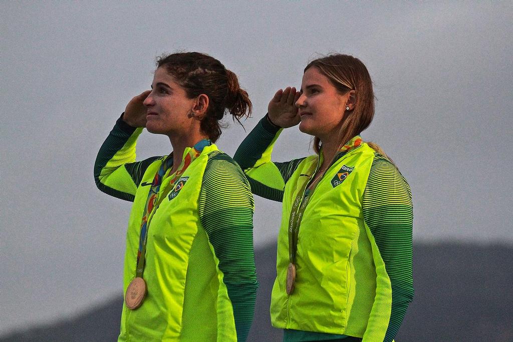 Gold Medalists Martine Grael and Kahena Kunze (BRA) as the Brazilian flag is raised at the 49erFX Medal ceremony - 2016 Sailing Olympics - photo © Richard Gladwell www.photosport.co.nz