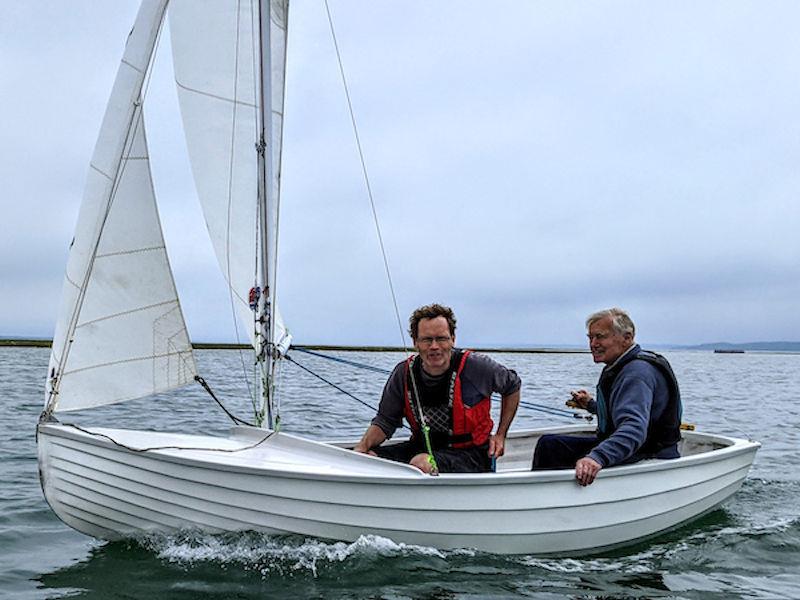 Yachtsman, boatbuilder and 1977 Yachtsman of of the Year award winner Jeremy Rogers from Lymington, enjoying one of his last sails with son David Rogers in one of the Keyhaven Scows that Jonathan built photo copyright Mark Jardine / PPL taken at Keyhaven Yacht Club and featuring the Scow class