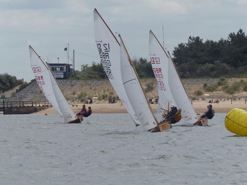 In formation with the Coastguart hut in the background during the Sharpie Nationals at Wells SC photo copyright Zoe Dunford taken at Wells Sailing Club and featuring the Sharpie class