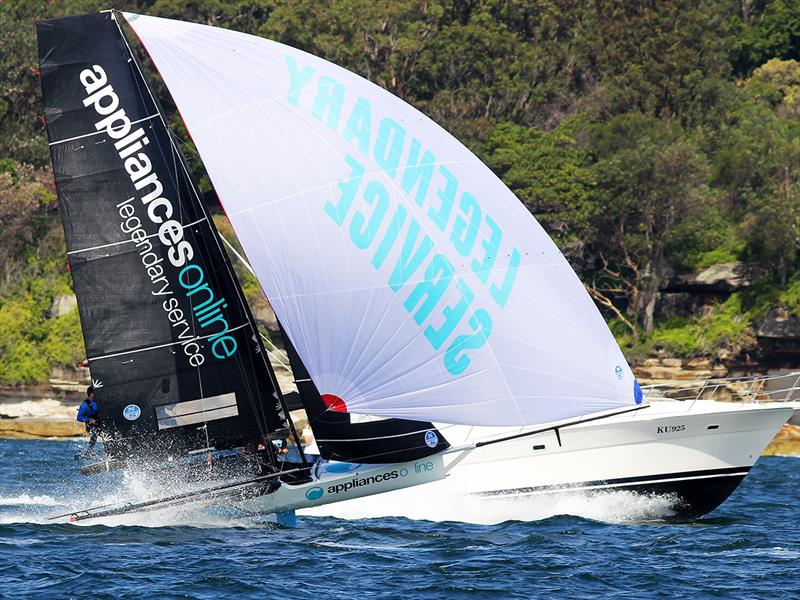 The appliancesonline team take on a power boat as they race up the harbour photo copyright Frank Quealey taken at Australian 18 Footers League and featuring the 18ft Skiff class