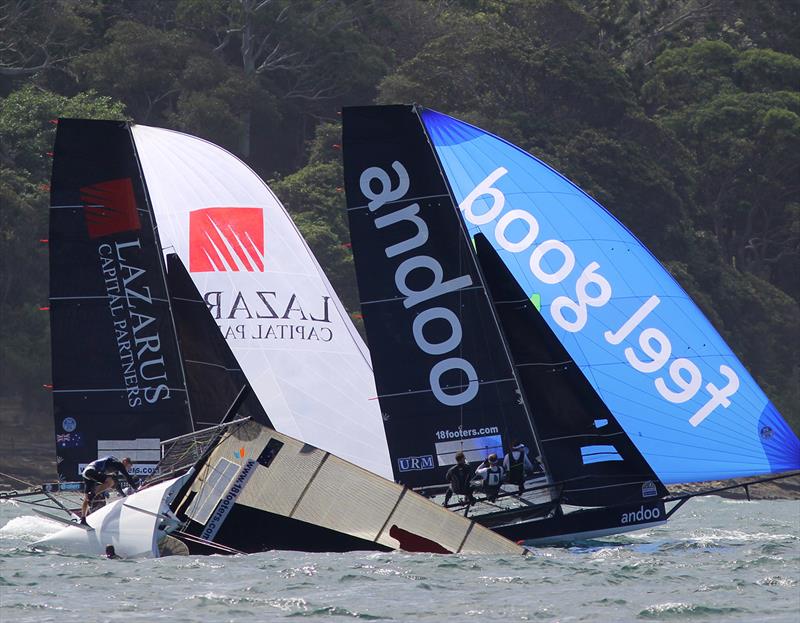 Andoo and Lazarus Capital Partners race past a capsized Bird and Bear during Race 8 of the 18ft Skiff Australian Championship photo copyright Frank Quealey taken at Australian 18 Footers League and featuring the 18ft Skiff class