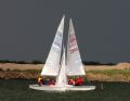 Race winners Alan Williams and Liz Crouch cross in front of Richard and Nicky Lambert during a Blue Circle Snipe open in 2006 © Richard Lambert