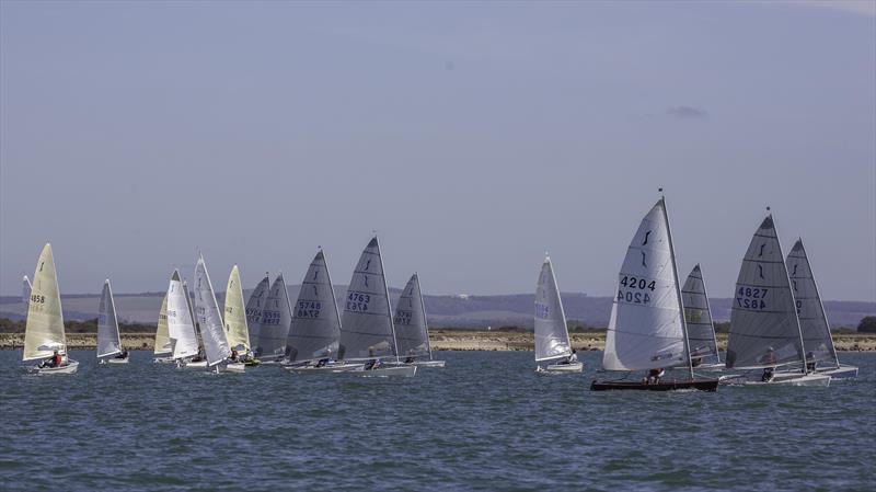 Fleet splits after the start of Race 2 during the Mengeham Rythe Solo Open photo copyright Graeme Macdonald taken at Mengeham Rythe Sailing Club and featuring the Solo class