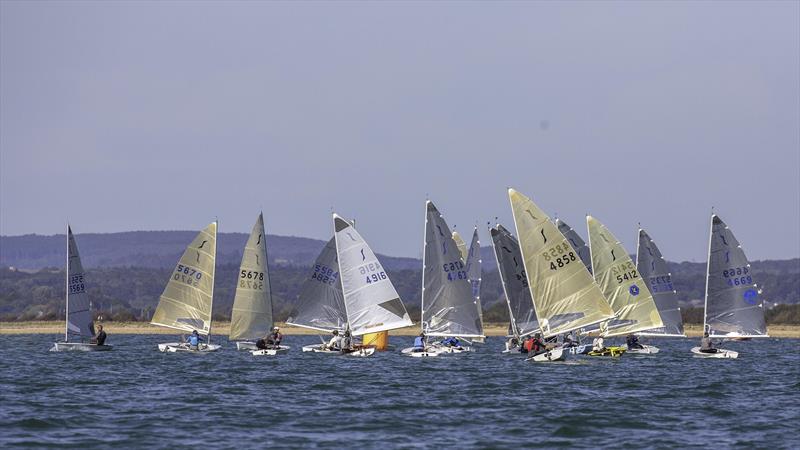 Nick Rawlins leads the fleet from a bunched leeward mark during the Mengeham Rythe Solo Open photo copyright Graeme Macdonald taken at Mengeham Rythe Sailing Club and featuring the Solo class