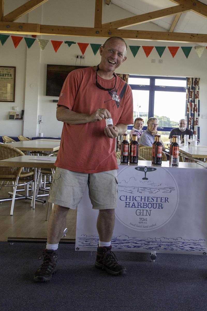 Happy winner overall Reger Bennet who also won one of the Chichester Harbour Gin spot prizes during the Mengeham Rythe Solo Open photo copyright Graeme Macdonald taken at Mengeham Rythe Sailing Club and featuring the Solo class