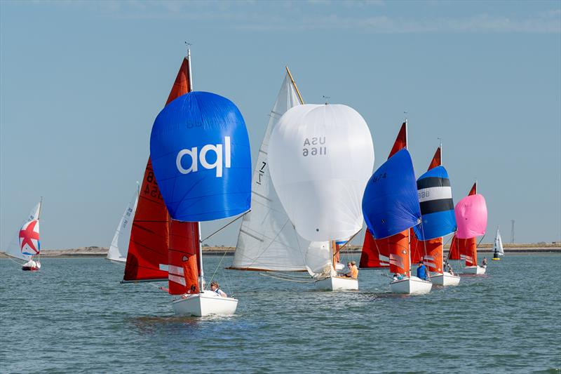 East Coast One Design boat chasing Squibs during Burnham Week 2024 photo copyright Petru Balau Sports Photography / sports.hub47.com taken at Royal Corinthian Yacht Club and featuring the Squib class