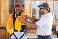 RCYC Student Ovayo Myira displaying essential safety wear aboard the Nave Italia