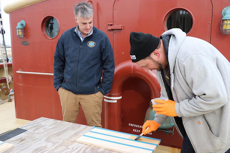 Dan O'Connor from Jamestown Distributors instructs a student in the application of varnish photo copyright Lisa Goodwin taken at  and featuring the Tall Ships class