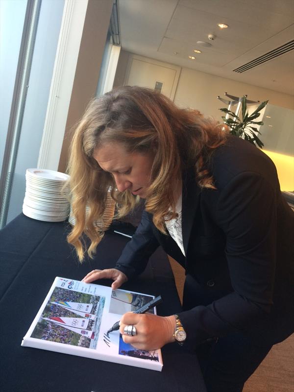 Annie Lush signing a canvas for the Topper competition photo copyright Kirsten Percival taken at RYA Dinghy Show and featuring the Topper class