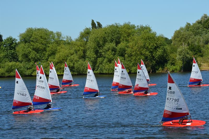 The fleet chasing down Will Thomas during Topper Midlands Traveller Round 4 at Swarkestone photo copyright Victoria Turnbull taken at Swarkestone Sailing Club and featuring the Topper class
