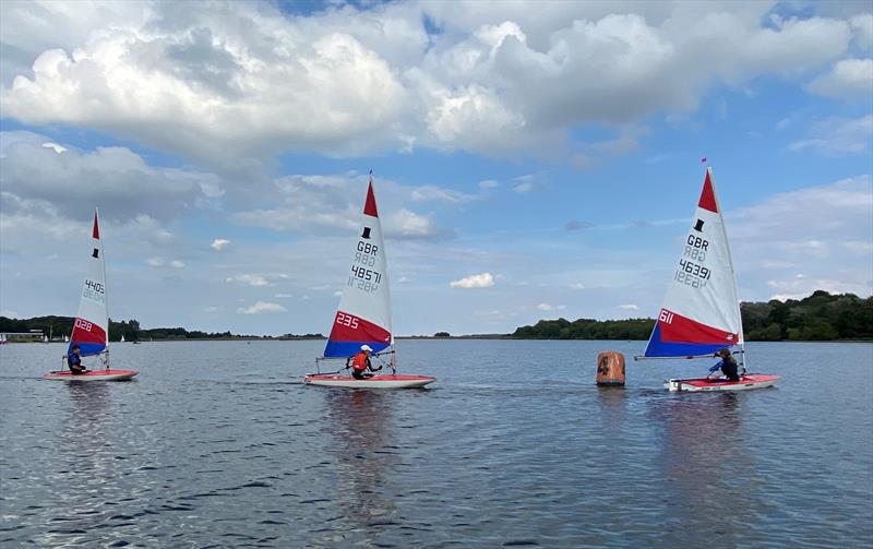 Leaders battling out for the event win during Midlands Topper Traveller Round 1 at Staunton Harold photo copyright Tom Mawby-Groom taken at Staunton Harold Sailing Club and featuring the Topper class