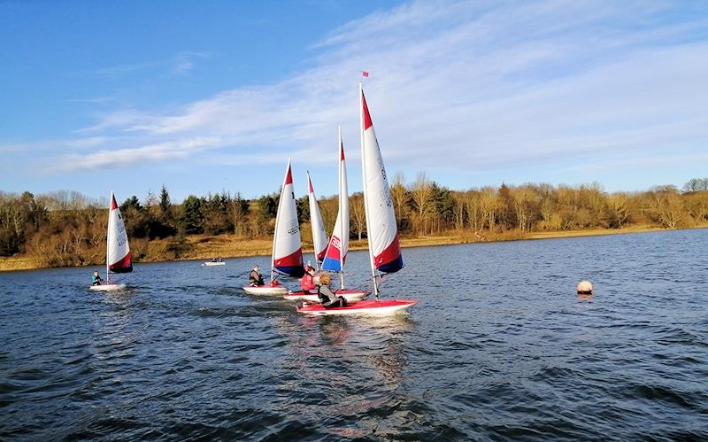 Roo Purves leading the Toppers through the first gate from a reaching start in the STRA Schools Sprints at Linlithgow Loch photo copyright Tom Goodman taken at  and featuring the Topper class