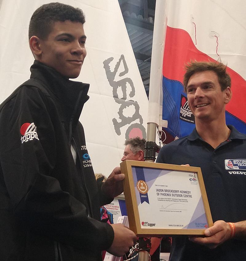 International Topper Re-activation Competition Winner Jadon Brockdorff-Kennedy presented with his award by Dylan Fletcher photo copyright Phoenix Outdoor Centre taken at RYA Dinghy Show and featuring the Topper class