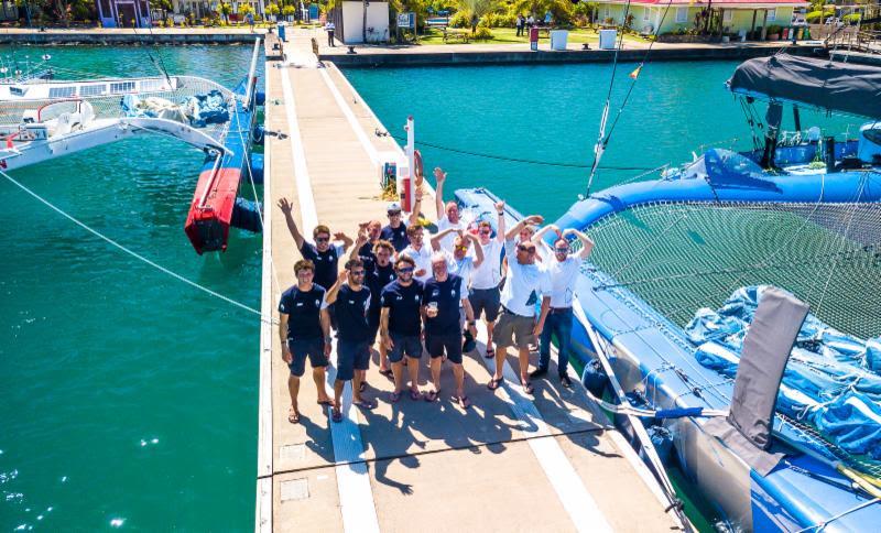 Magnificent sight on the docks at C&N Port Louis Marina, with the two trimarans and crews celebrating their victories - 2018 RORC Transatlantic Race photo copyright RORC / Arthur Daniel taken at Royal Ocean Racing Club and featuring the Trimaran class