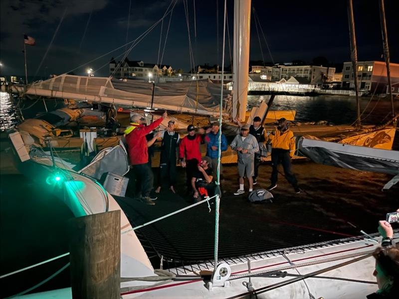 Rick Warner (far left, red jacket) and crew celebrate their world-record time photo copyright Laura Muma taken at Chicago Yacht Club and featuring the Trimaran class