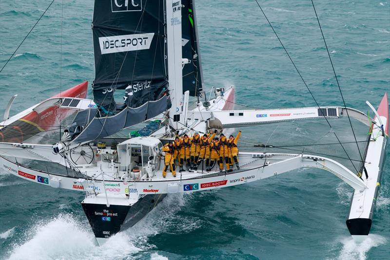 Arrival of Alexia Barrier and her crew of The Famous Project CIC Dee Caffari, Annemieke Bes, Deborah Blair, Molly LaPointe, Támara Echegoyen, Stacey Jackson and Rebecca Gmür Hornell – aboard Maxi Trimaran IDEC Sport off Ouessant, after Jules Verne Trophy photo copyright Lloyd / Jmliot Images / CIC taken at  and featuring the Trimaran class