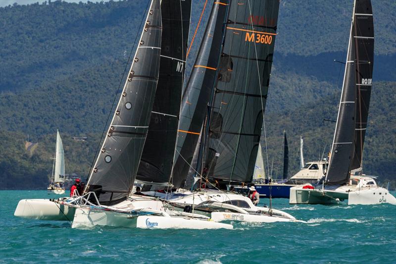 Beatrix leads off the start of Multihull Racing Division 2 last year at Airlie Beach Race Week photo copyright Andrea Francolini / ABRW taken at Whitsunday Sailing Club and featuring the Trimaran class