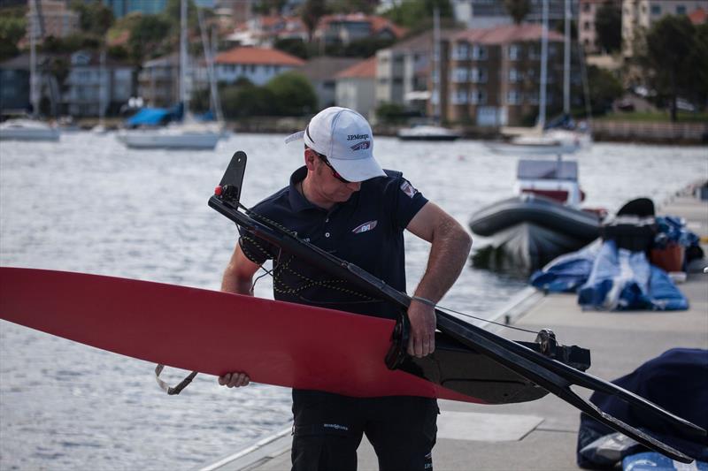 Shore team boat builder, Ian 'Mucky' McCabe, gets to work on the rudders of J.P. Morgan BAR photo copyright Harry Kenney-Herbert taken at  and featuring the Extreme 40 class