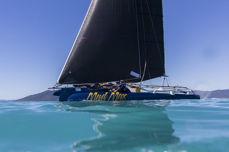 The multihull Mad Max under a shimmering Airlie Beach day - Airlie Beach Race Week photo copyright Andrea Francolini taken at Whitsunday Sailing Club and featuring the Extreme 40 class