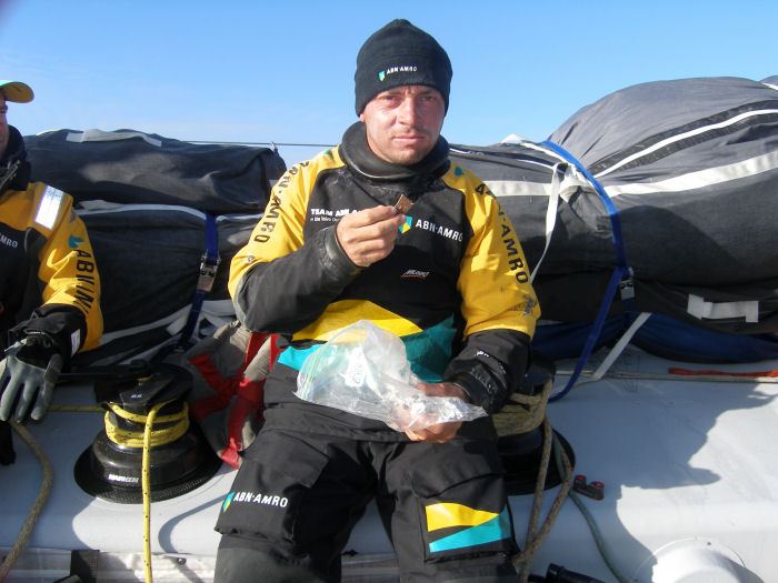 Helmsman Rob Greenhalgh tucks into a snack on deck on Volvo Open 70 ABN AMRO ONE as they head towards Cape Horn photo copyright TEAM ABN AMRO taken at  and featuring the Volvo 70 class