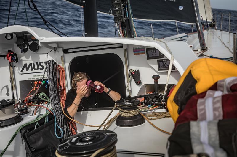 Onboard team Brunel British sailor Annie Lush rinses saltwater off her face photo copyright Martin Keruzore / Volvo Ocean Race taken at  and featuring the Volvo One-Design class