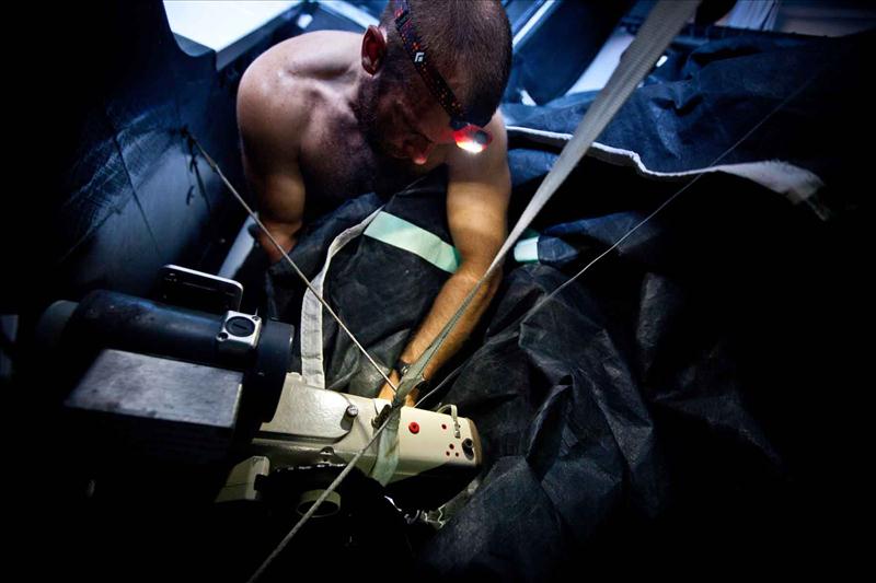 Ryan Godfrey at work repairing a ripped sail on PUMA Ocean Racing in leg 4 photo copyright Amory Ross / PUMA Ocean Racing / Volvo Ocean Race taken at  and featuring the Volvo 70 class