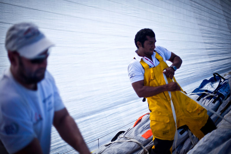 Adil Khalid puts straps on the old sail during a peel onboard Abu Dhabi Ocean Racing during leg 6 of the Volvo Ocean Race photo copyright Nick Dana / Abu Dhabi Ocean Racing / Volvo Ocean Race taken at  and featuring the Volvo 70 class