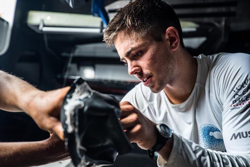 Volvo Ocean Race Leg 4, Melbourne to Hong Kong, Day 6 onboard Turn the Tide on Plastic. Liz Wardley and Bleddyn Mon fix the neck seal on a smock.Photo by Brian Carlin / Volvo Ocean Race. 07 January,. - photo © Brian Carlin / Volvo Ocean Race