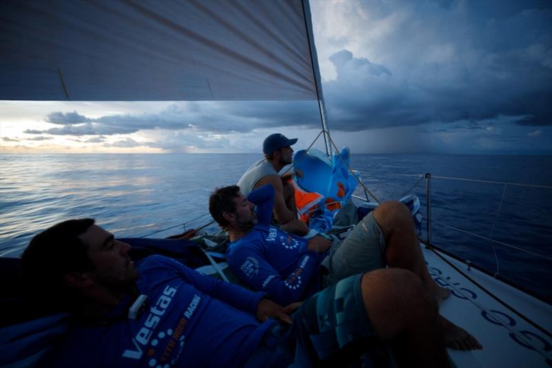 Volvo Ocean Race Leg 4, Melbourne to Hong Kong, day 11, rain clouds line the horizon at sundown while Nick Dana, Simon Fisher `SiFi` and Mark Towill await their influences on board Vestas 11th Hour. - photo © Amory Ross / Volvo Ocean Race
