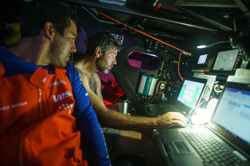 Leg 4, Melbourne to Hong Kong, day 14, navigator Simon Fisher \`SiFi\` and Mark Towill discuss the latest position report in the nav station on board Vestas 11th Hour photo copyright Amory Ross / Volvo Ocean Race taken at  and featuring the Volvo One-Design class