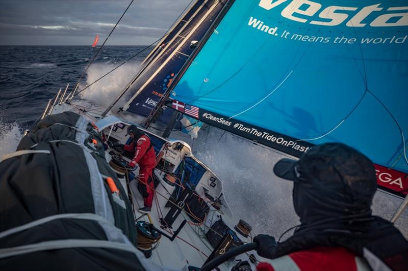 Volvo Ocean Race Leg 7 from Auckland to Itajai, day 05 on board Vestas 11th Hour. Toni Mutter helming while Tom Johnson is fixing the jib, Mapre is now right in front of us. 22 March - photo © Jeremie Lecaudey / Volvo Ocean Race