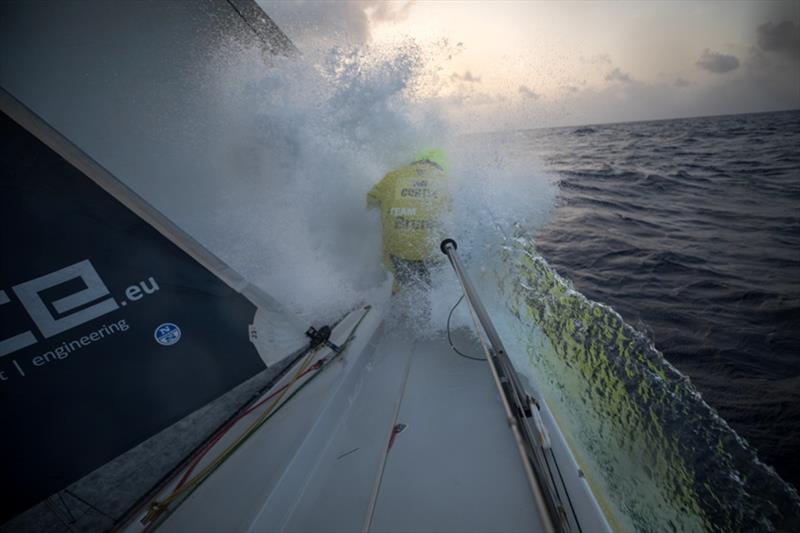 Volvo Ocean Race Leg 8 from Itajai to Newport, day 10, on board Brunel. Nina Curtis cleans weeds from the bow. - photo © Sam Greenfield / Volvo Ocean Race