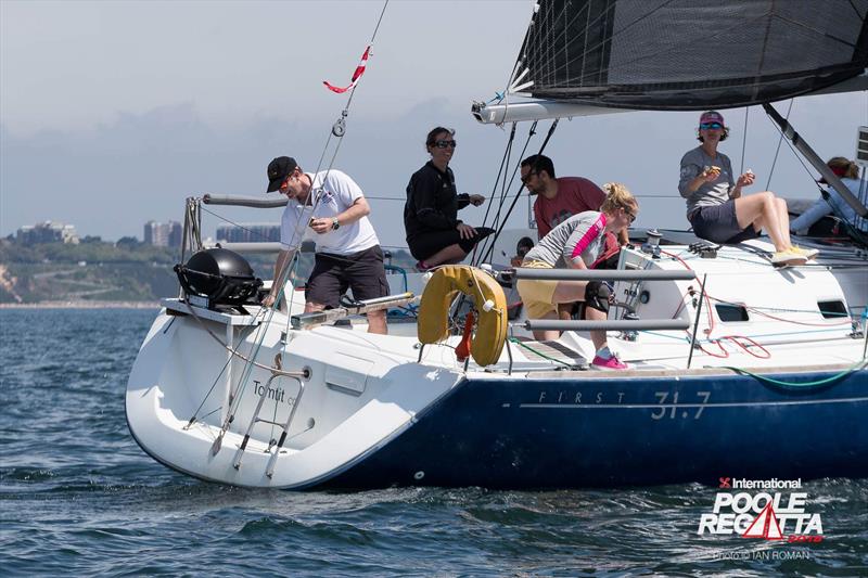 Ed Wilton barbeques while helming on Tom Tit during the International Paint Poole Regatta 2018 photo copyright Ian Roman / International Paint Poole Regatta taken at  and featuring the VPRS class