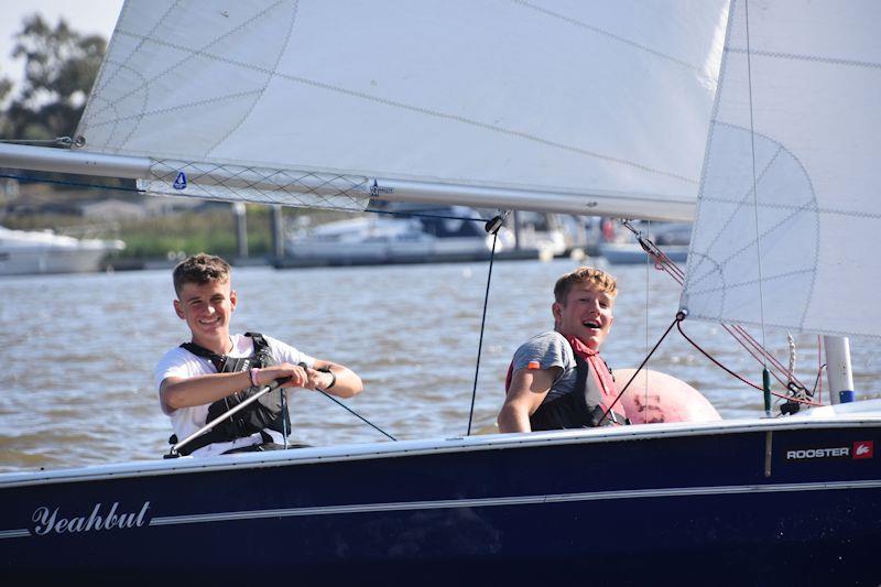 Max Stratford and Olly Jones sense a photo-opportunity while rounding a racing mark - 28th Broadland Youth Regatta photo copyright Trish Barnes taken at Waveney & Oulton Broad Yacht Club and featuring the Wanderer class